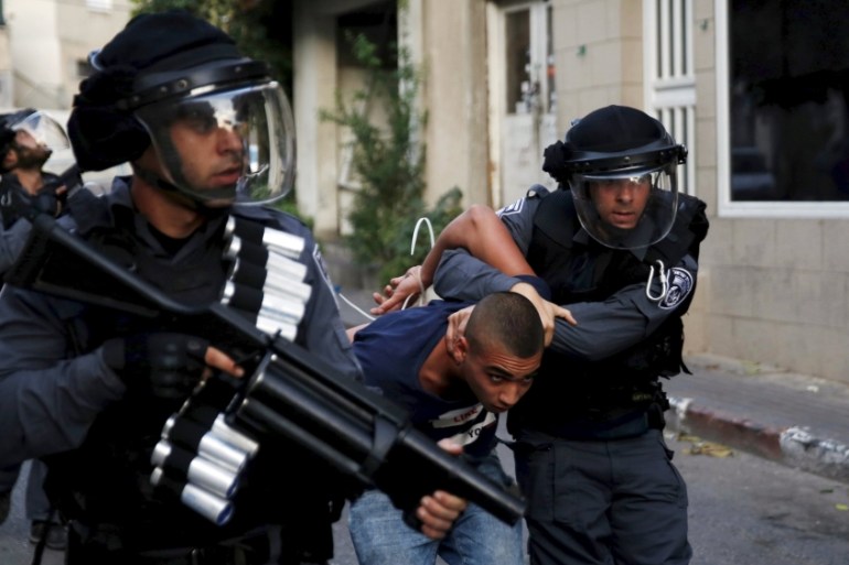 Israel police detain an Israeli Arab man during clashes in Nazareth at northern Israel