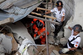 Rescue team members search for mudslide victims in Santa Catarina Pinula, on the outskirts of Guatemala City