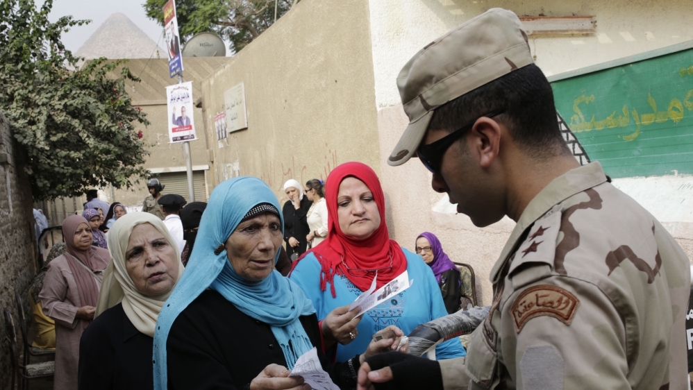 Soldiers have been deployed to polling booths amid threats of attack by ISIL-aligned fighters [Amr Nabil/AP]
