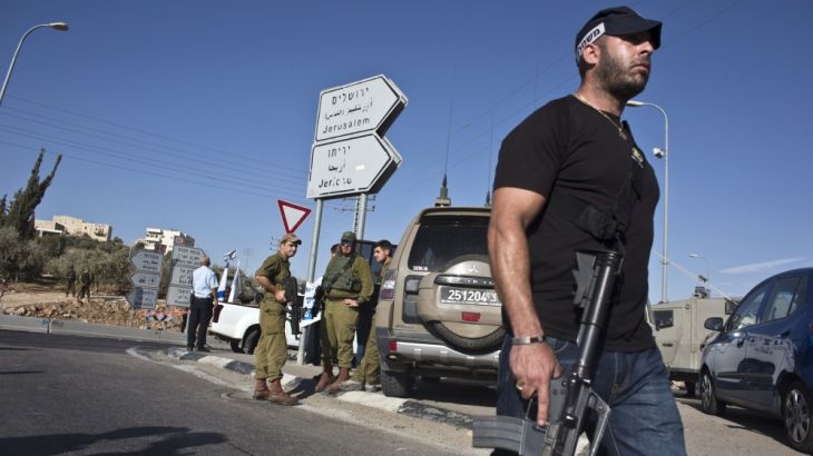 An Israeli policeman patrols at the scene of a stabbing attack near the West Bank Jewish settlement of Adam, north of Jerusalem