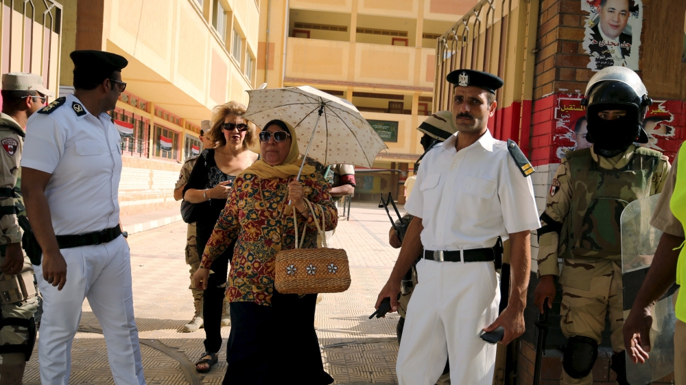 Women leave a polling station after casting their ballots in Alexandria [Asmaa Waguih/Reuters]