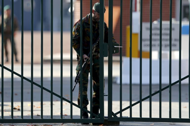 A Belgian soldier secures a gate of a military barracks in Flawinne