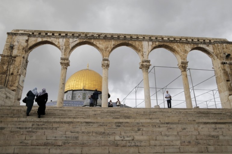 People walk near the Dome of the Rock in Jerusalem
