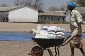 A Zimbabwean woman collects her monthly food ration from a distribution center in rural Mupinga area in Chiredzi, Zimbabwe