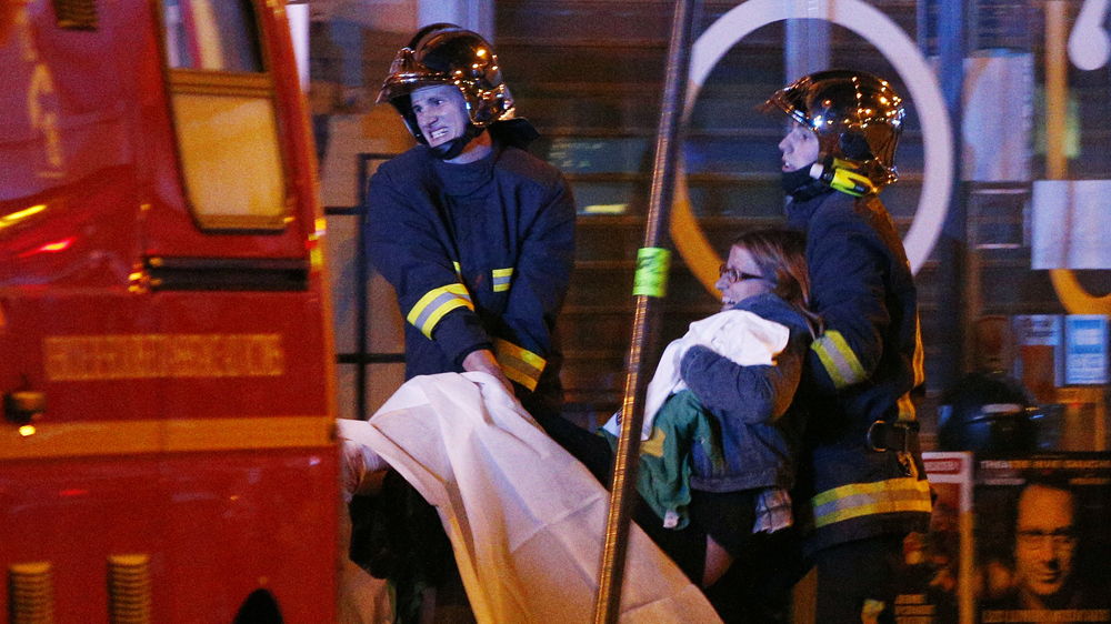 Wounded people were evacuated from the scene of a hostage situation at the Bataclan theatre in Paris [Yoan Valat/EPA]