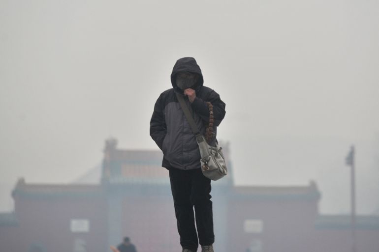 Woman in tich smog, Shenyang, Liaoning Province of China