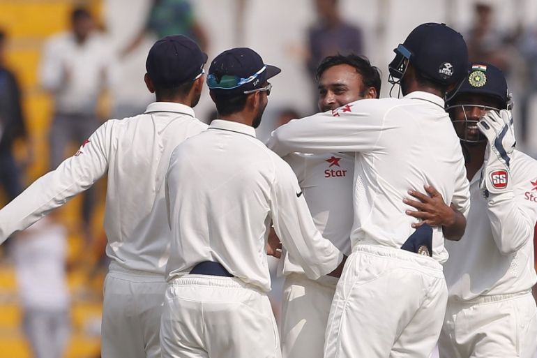 India''s Mishra celebrates with his teammates after dismissing South Africa''s de Villiers during the third day of their first cricket test match, in Mohali
