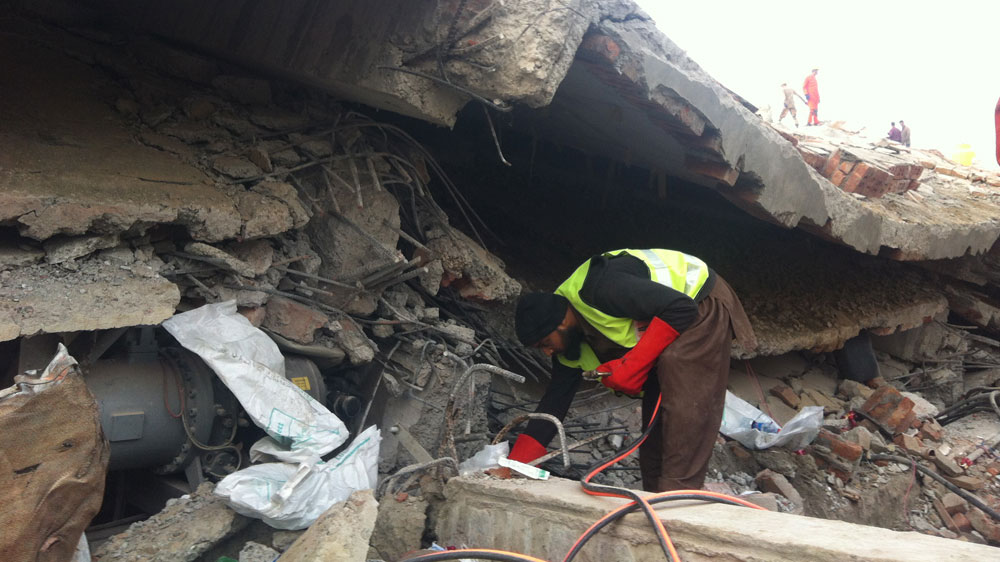 Rescue officials said dozens of labourers remain trapped under the rubble [Kamal Hyder/Al Jazeera]