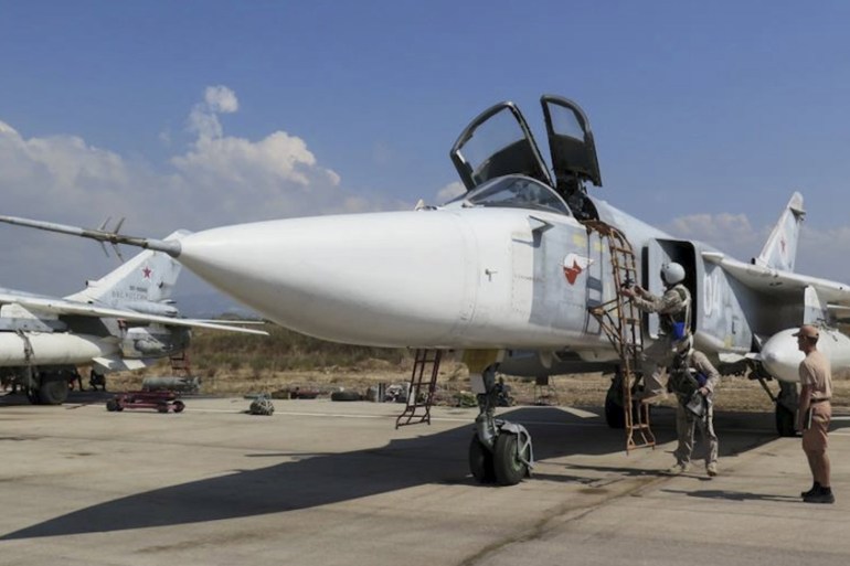 Russia''s Defence Ministry handout photo shows pilots of Russian Sukhoi Su-24 fighter jet preparing before flight at Hmeymim air base near Latakia in Syria