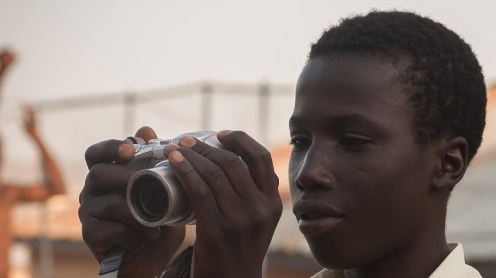Twenty-year-old Emmanuel David, whose father was killed when he was six years old, says learning photography is one of the best things that has ever happened to him [Ruth McDowall/Al Jazeera]