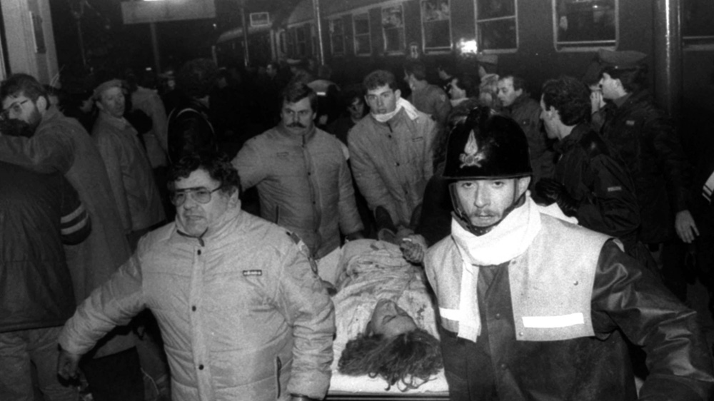 A wounded woman receives assistance following the Bologna train station bombing on August 2, 1980 [The Associated Press]