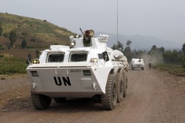 U.N. peacekeepers drive in their APC as they patrol the road towards Kibati