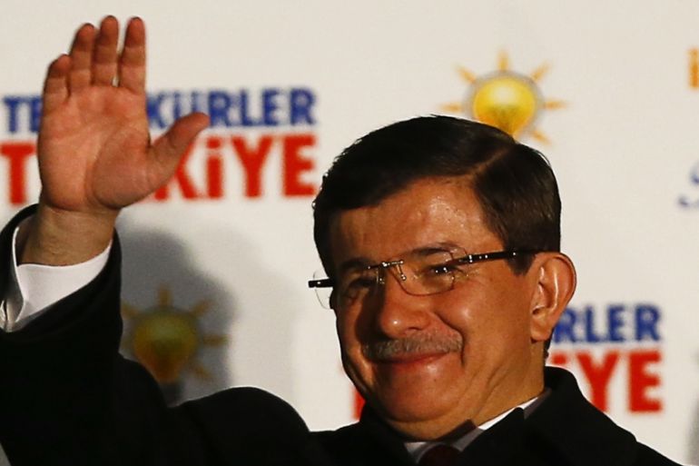 Turkish Prime Minister Davutoglu waves to supporters from the balcony of the AK Party headquarters in Ankara