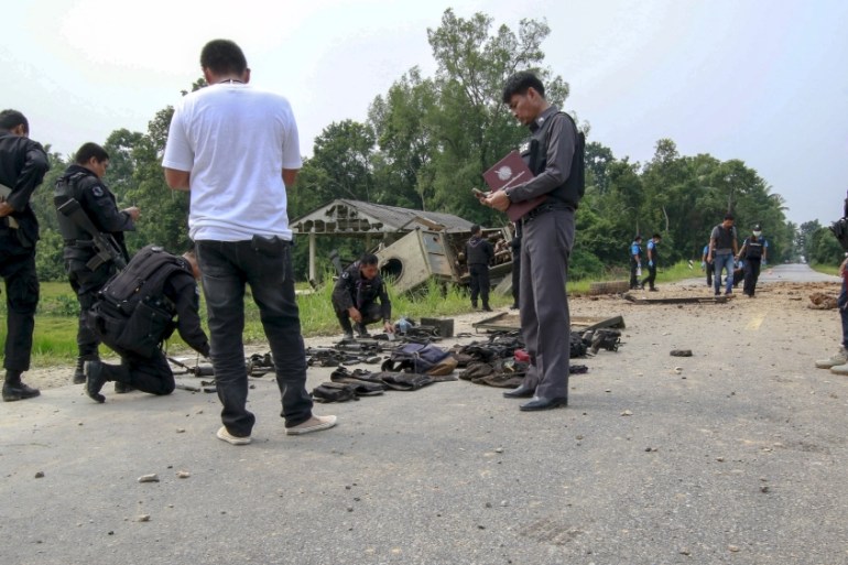 Military personnel and forensic experts inspect the site where soldiers were attacked by suspected Muslim militants at Sai Buri district in the troubled southern province of Pattani,