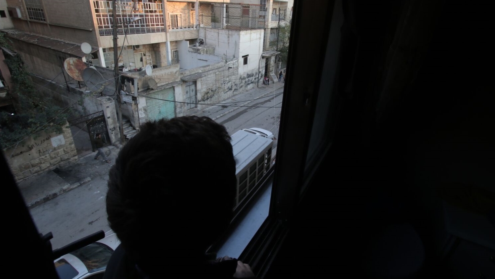 From his bedroom window, Yusuf watches his friends going to school; he wishes he could join them [Zouhir Al Shimale/Al Jazeera]