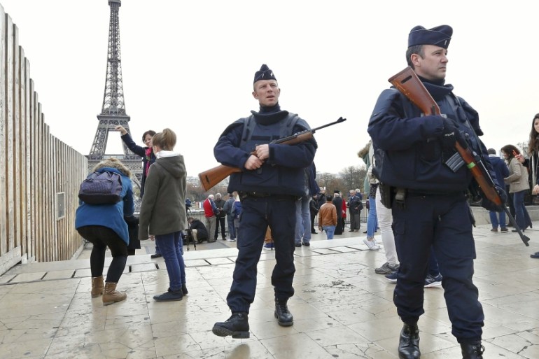 Police patrol near the Eiffel Tower the day after a series of deadly attacks in Paris
