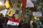 Protesters hold Russian and Syrian national flags, with the posters reading: 'Turkey to account!' at the Turkish embassy in Moscow [AP]