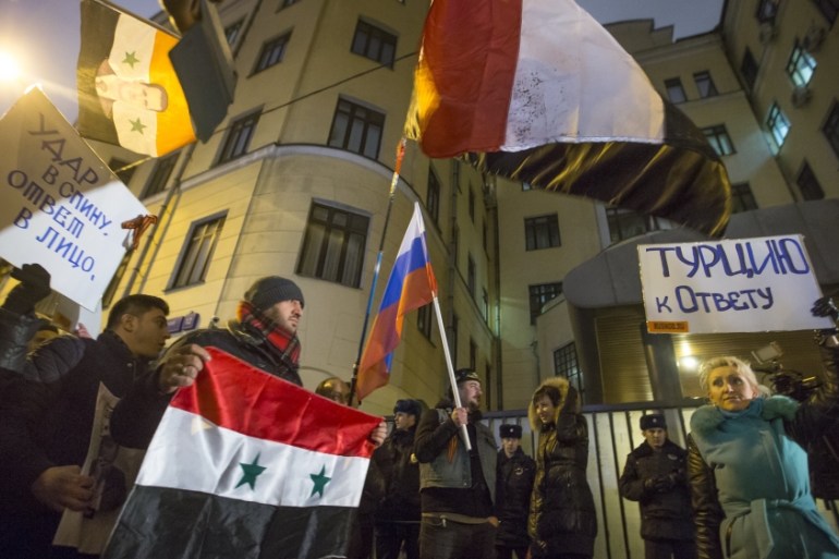 Protesters hold Russian and Syrian national flags and posters reading ''Turkey to account!'' and ''Stab in the back - a response in the face!'' during a picket at the Turkish Embassy in Moscow, Russia [AP