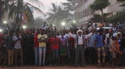 People cheer Malian soldiers in front of the hotel in Bamako [Reuters]