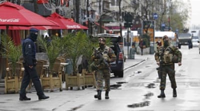 Belgian soldiers and a police officer patrol in central Brussels [Reuters]
