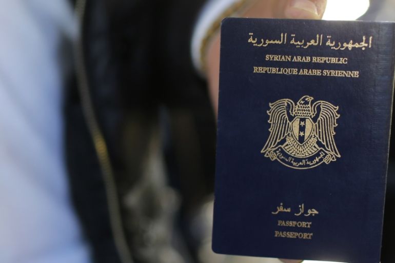 Christian Syrian refugee Ghassan Aleid displays his Syrian passport at a terminal at the Charles-de-Gaulle Airport in Roissy