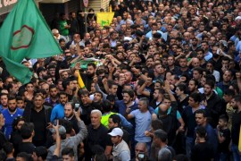 Relatives and comrades march as they carry the coffin of Hussein Hojeij, a member of Amal movement party, who was killed in the two explosions that occurred on Thursday