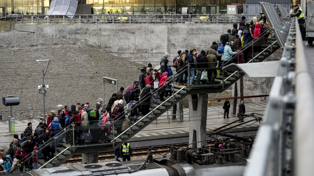 Police organise lines of refugees arriving from Denmark in Malmo, Sweden [Reuters]