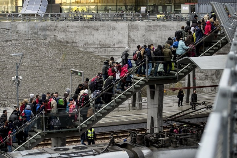 Police organise the line of refugees at on the stairway leading up from the trains arriving from Denmark at the Hyllie train station outside Malmo, Sweden [Reuters]