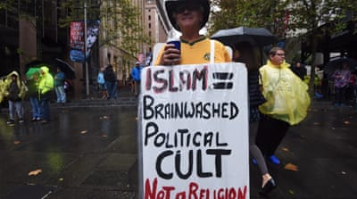 Protesters supporting the 'Reclaim Australia' group hold anti-Muslim placards during a protest rally in Sydney, Australia [EPA]