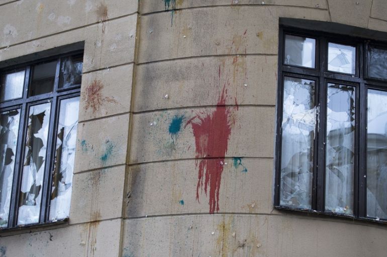 Windows are shattered and walls have traces of pelted eggs after a protest at the Turkish E