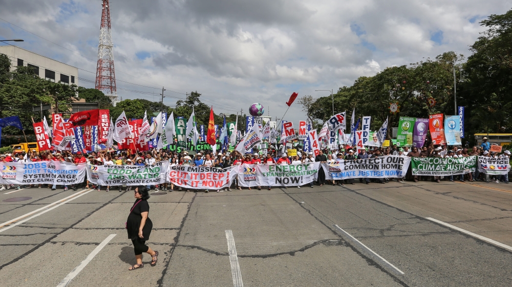 
A Filipino woman walks past demonstrators holding banners during the Global Climate March in Quezon City, northeast of Manila, Philippines [EPA]



 









People hold banners during the Global Climate March in Geneva [EPA]














People hold banners during the Global Climate March in Geneva [EPA]



People hold banners during the Global Climate March in Geneva [EPA]People walk past the art-work 'Where the Tides ebb and flow' by Argentinian artist Pedro Marzorati installed in a pond at the Montsouris park ahead of the COP21 World Climate Summit [Reuters]
Indian school children arrive to present a symbolic globe to the Indian Minister of State for Environment ahead of the COP21 climate change summit in Paris [EPA]

A polar bear-costumed person gestures during 'Earth Parade 2015' in Tokyo [EPA]

Police stand around a climate change protester who had been blocking train tracks in front a train which was supposed to take the German environment minister to the climate summit in Paris [EPA]
Employees put the final touches during the installation of the exhibition 'Paris de L'Avenir,' a showcase for tangible climate solutions in the context of COP21, in front of Paris City Hall [Reuters]