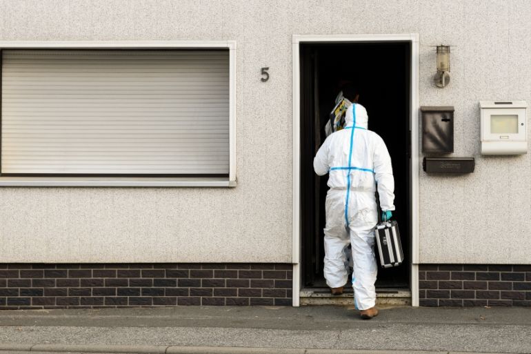 Police investigator in protective cloth enter a house in Wallenfels, southern Germany