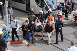 Israeli medics and emergency personnel evacuate a wounded from scene of a stabbing in Pisgat Zeev