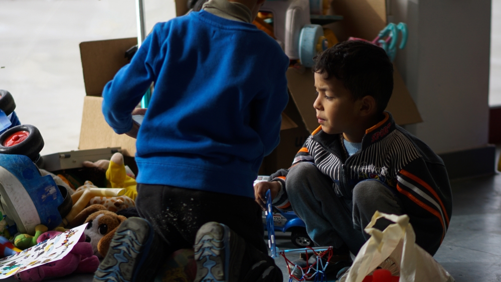 Children play in the temporary refugee center in Elliniko (Sorin Furcoi/Al Jazeera)