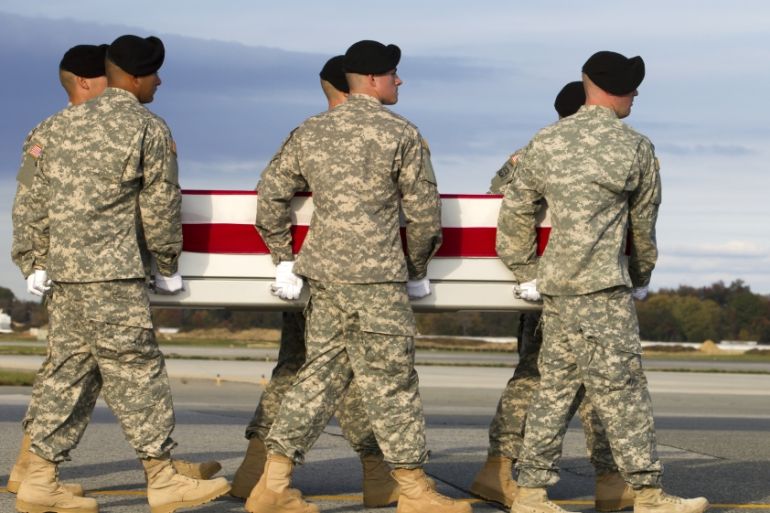 An army carry team carries the transfer case containing the remains of Army Master Sgt. Joshua L. Wheeler [AP]
