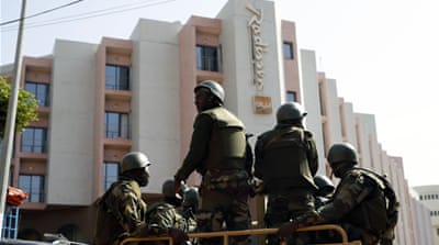 Soldiers from the presidential patrol outside the Radisson Blu hotel [AP]