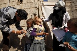 Health workers administer polio vaccine for children during a house-to-house vaccination campaign in Yemen''s capital Sanaa