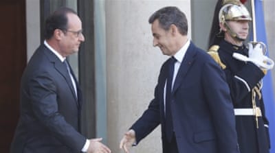 France's President Francois Hollande greets former President Nicolas Sarkozy [AP]