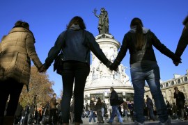 People hold hands to form a human solidarity chain near the site of the attack at the Bataclan concert hall in Paris