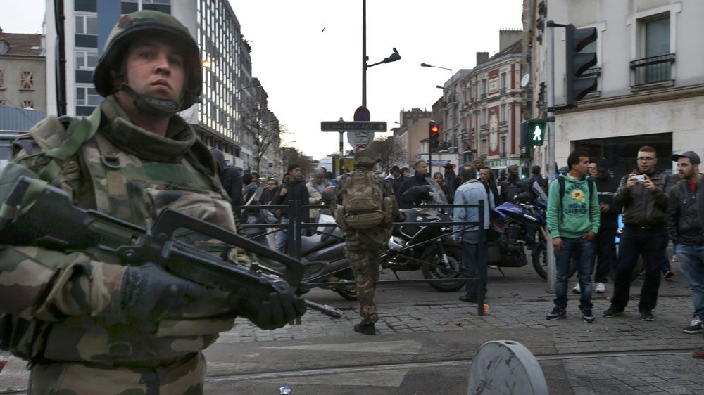 French soldiers secured the area as shots were exchanged in Saint-Denis in an operation to catch suspects [Jacky Naegelen/Reuters]