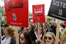 Women protesters carry banners as they chant slogans during a protest to express solidarity with Palestinians and against the escalation of Israeli-Palestinian violence, in Amman, Jordan
