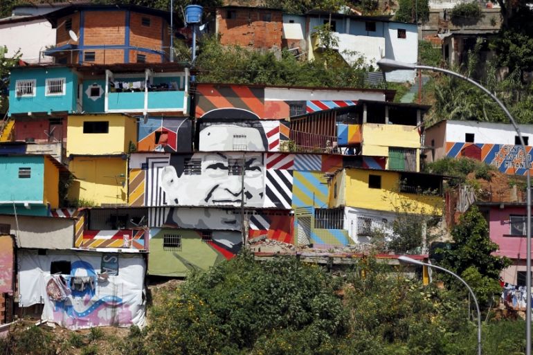 An image of Venezuela''s late President Hugo Chavez is painted on a house in a neighborhood in Caracas