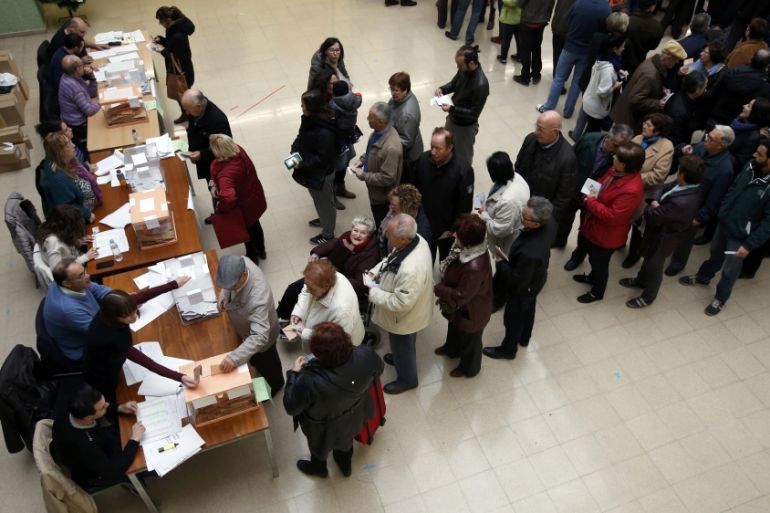 Voters queue at a polling station during voting in Spain''s general election in Barcelona