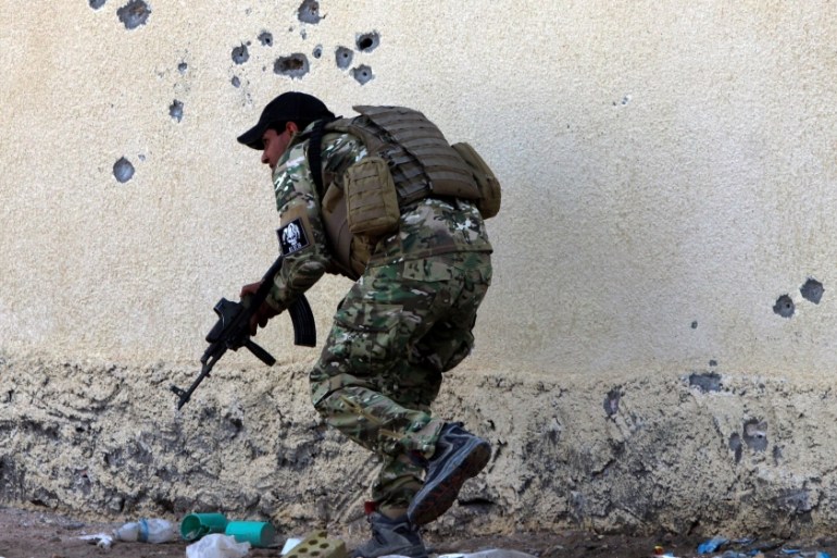 A member of the Iraqi armed forces takes up position during a military operation in the village of Sigariya, near Ramadi city [EPA]