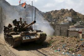 Soldiers loyal to Yemen''s government ride atop a tank in the country''s southwestern city of Taiz