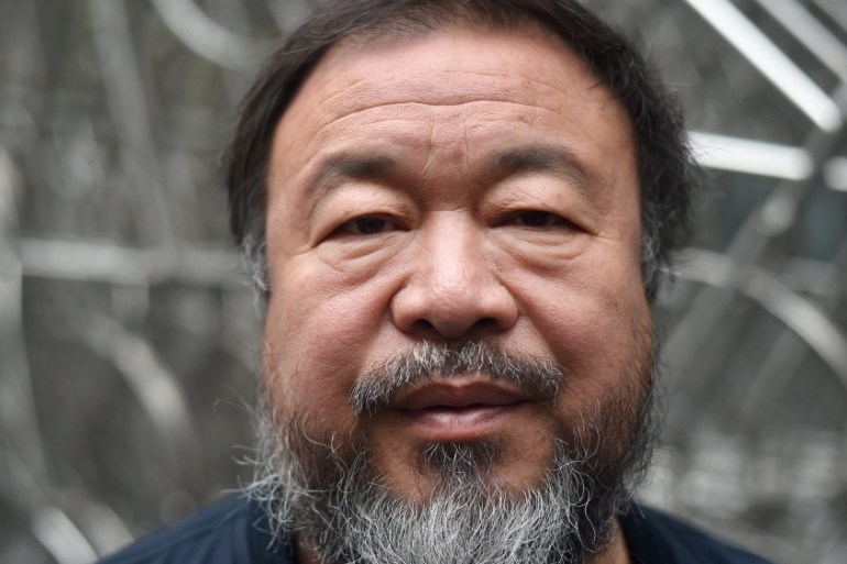 Ai WeiWei poses with new sculpture