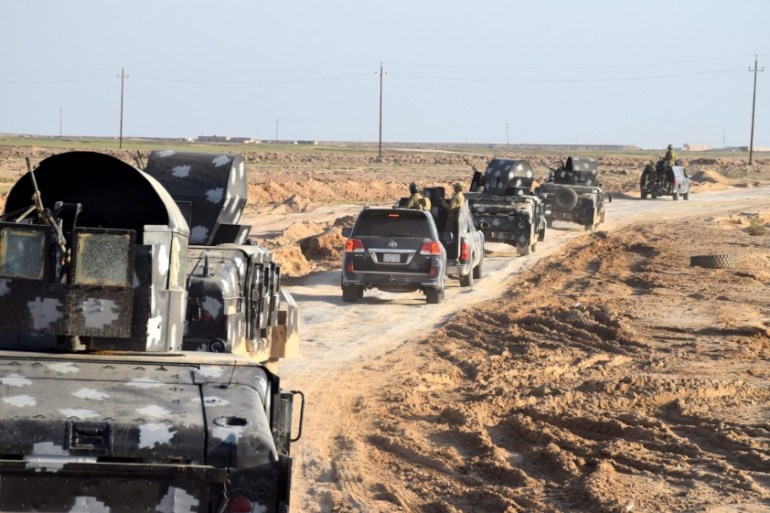 Iraqi military trucks advancing into an area at eastern Ramadi