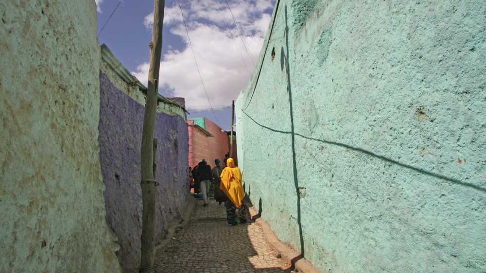 Alleyways painted in various cheerful pastel colours crisscross Ethiopia’s famous walled city of Harar [James Jeffrey/Al Jazeera] 