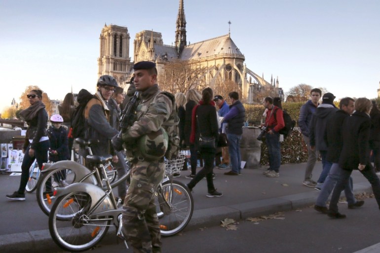 A soldier patrols on a bridge near Notre Dame cathedral following deadly attacks in Paris