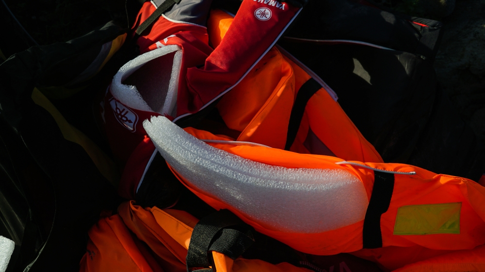Many refugees say their lives depended on life jackets stuffed with thin foam padding or nylon [Sorin Furcoi/Al Jazeera]